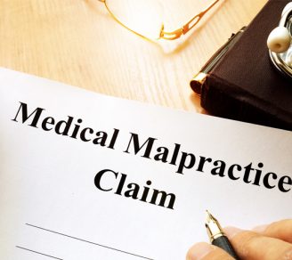 Paper with the words “Medical Malpractice Claim” on it