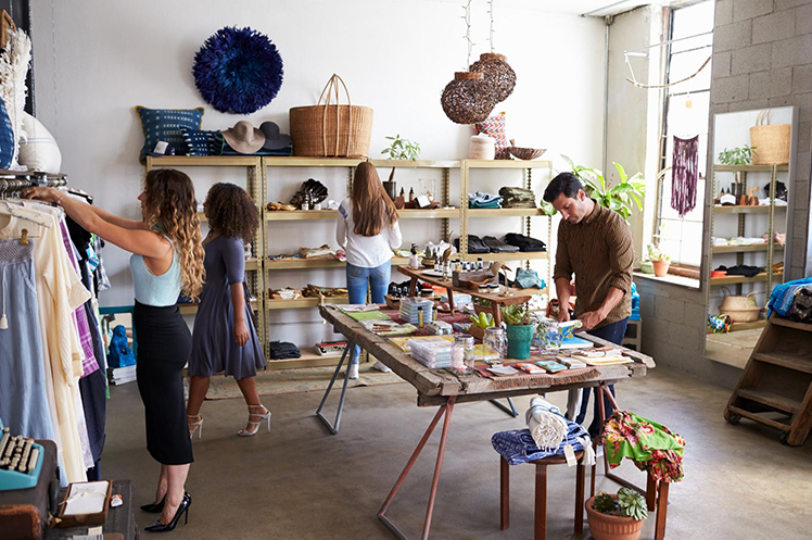 A photo of a boutique with shoppers looking around