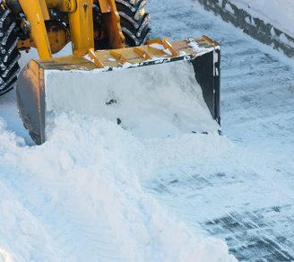 Close-up of a tractor clearing snow away