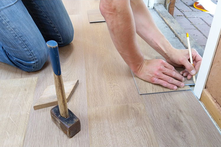 Close-up of general residential contractor at work with tools beside him