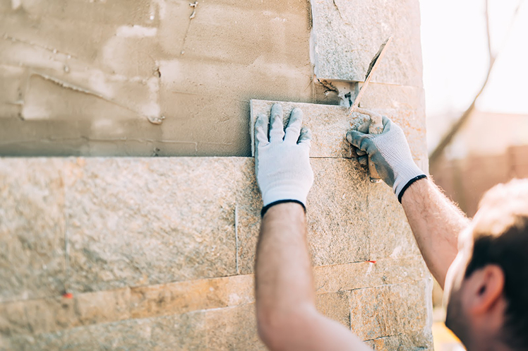 Stone mason contractor working on a wall
