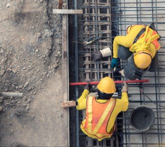 An overhead shot of two construction workers at work in a construction site