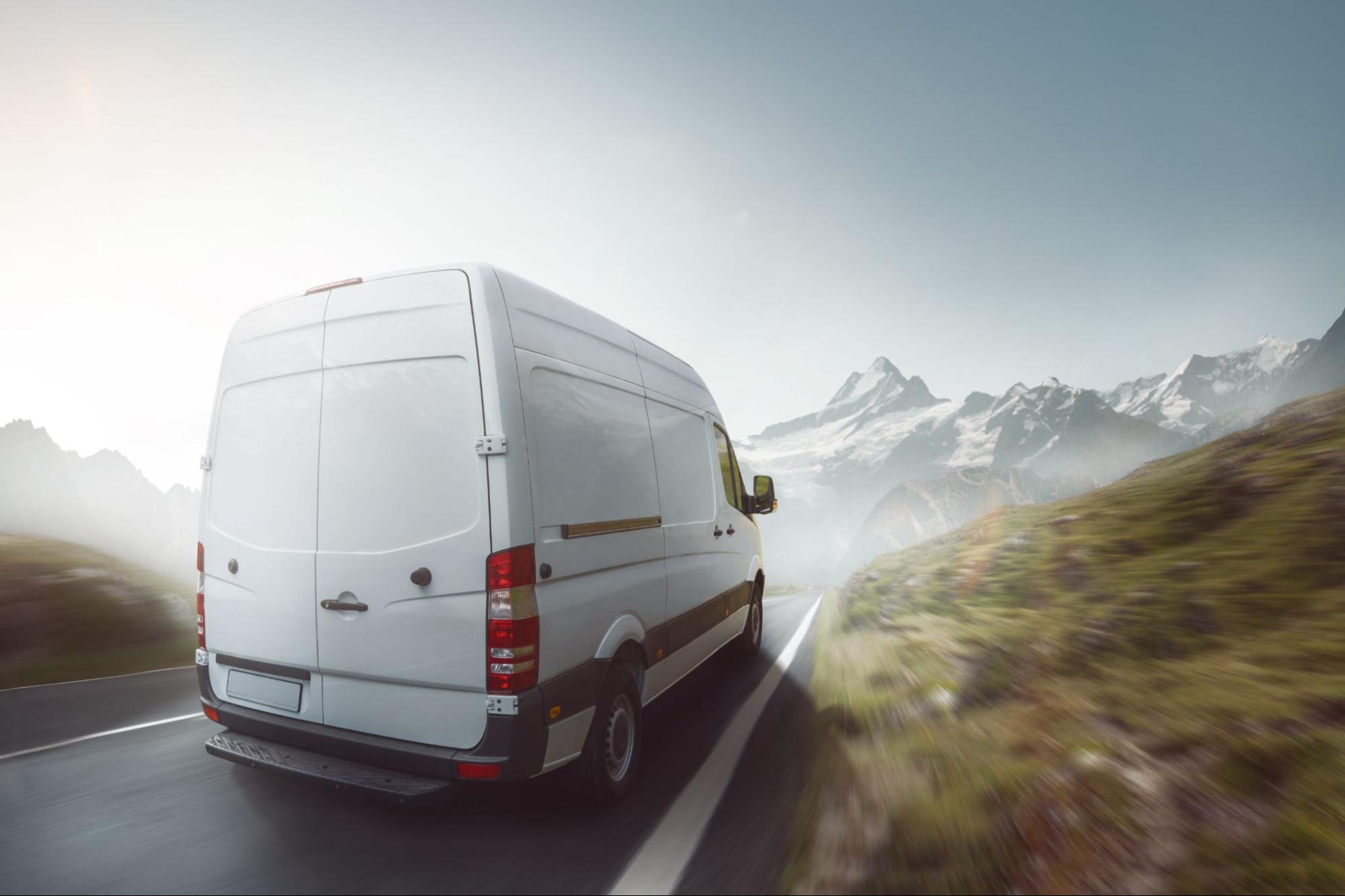 A commercial vehicle driving into a foggy road