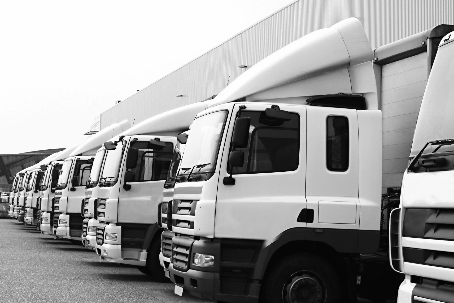 Fleet of commercial vehicles parked outside a building