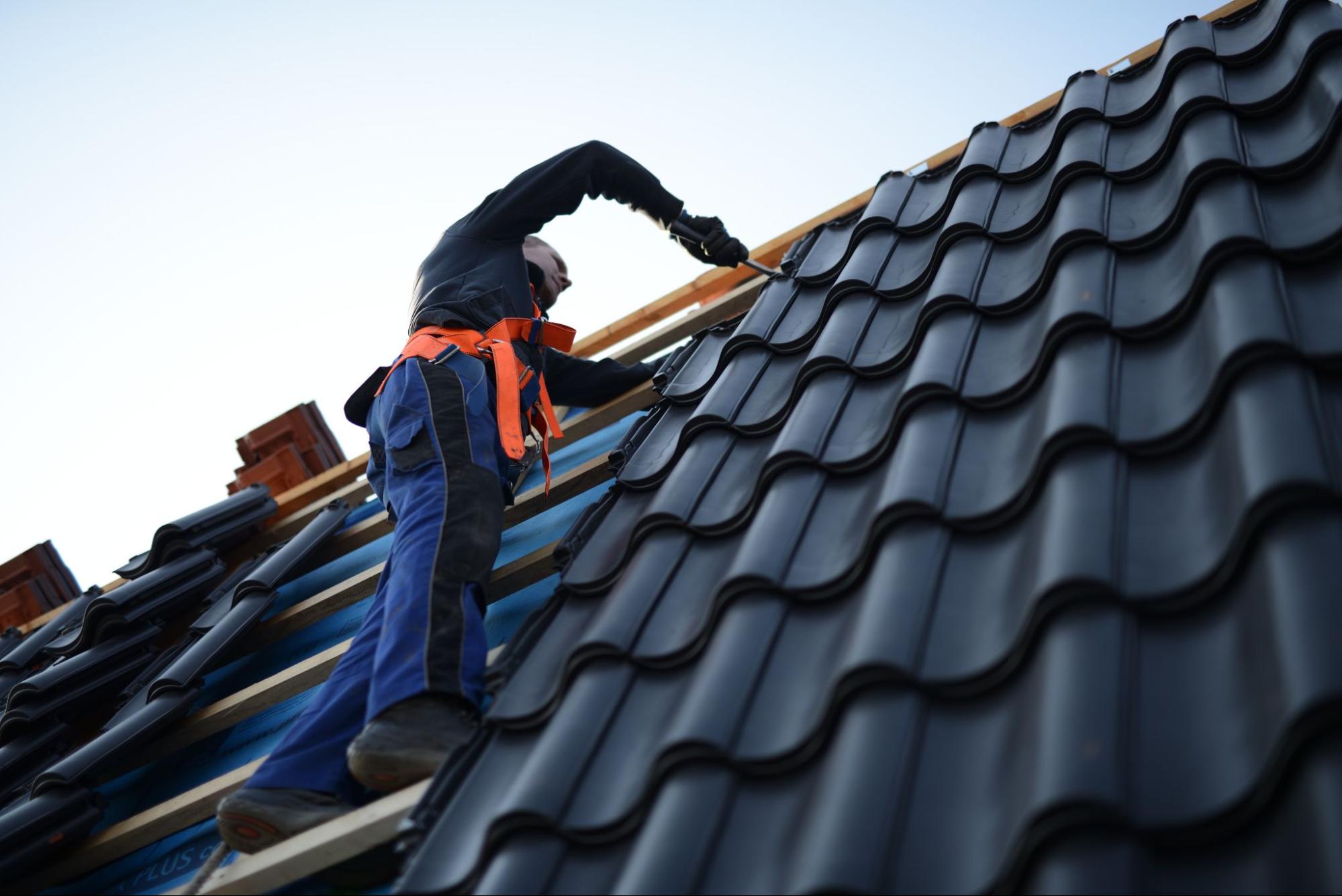 A roofing contractor doing maintenance work on the roof