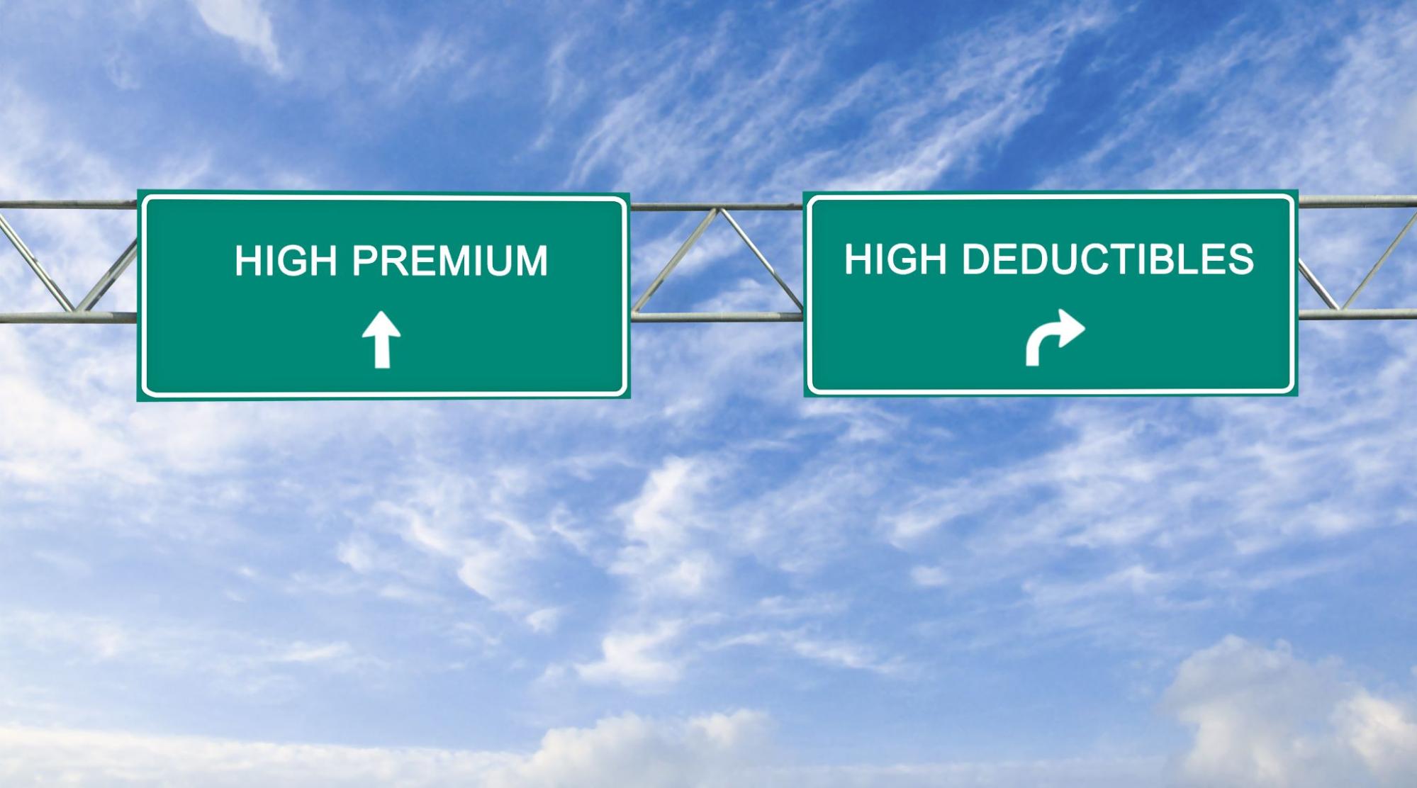 Road signs representing the choice between high deductibles or high premiums