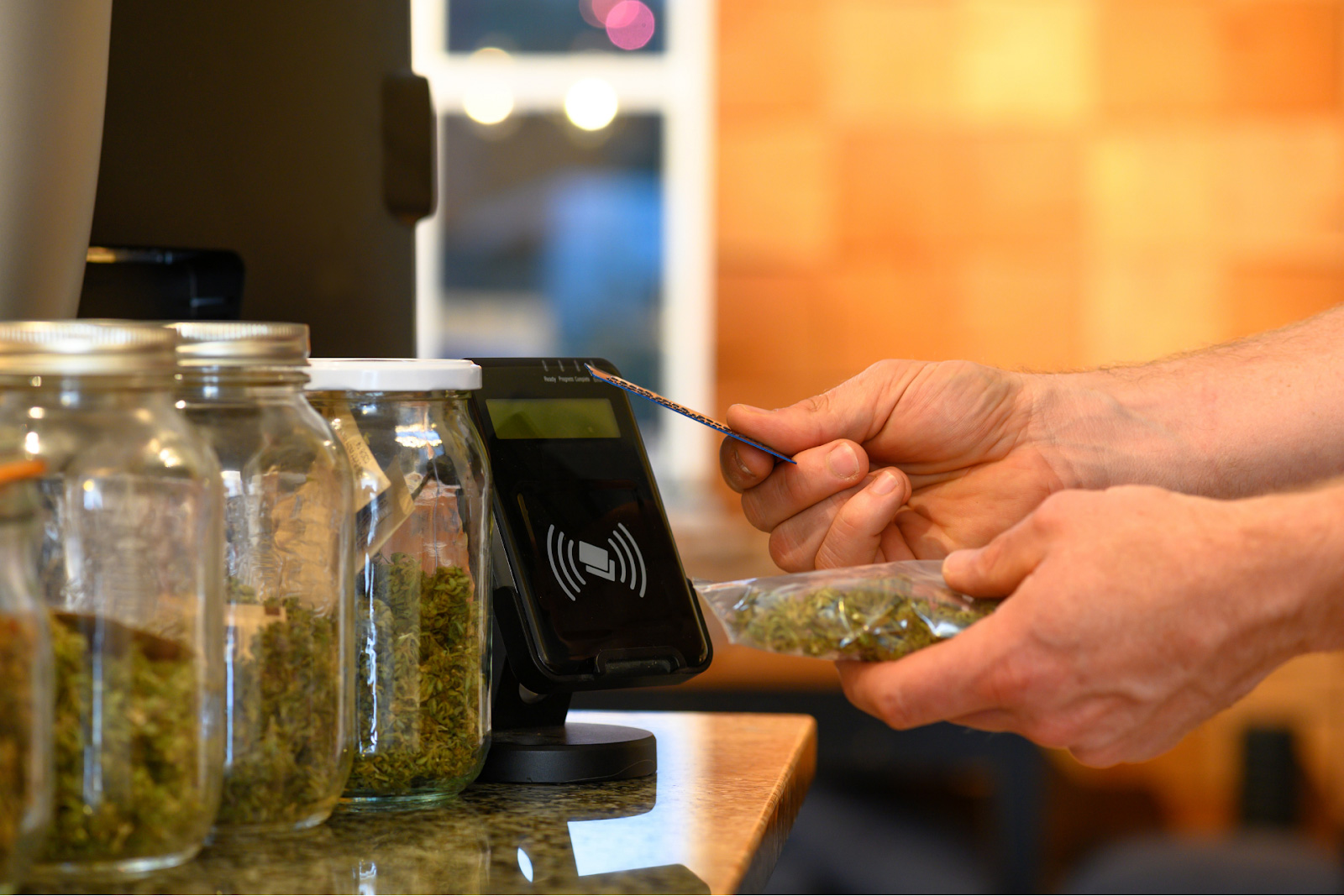 A customer purchasing cannabis using a credit card