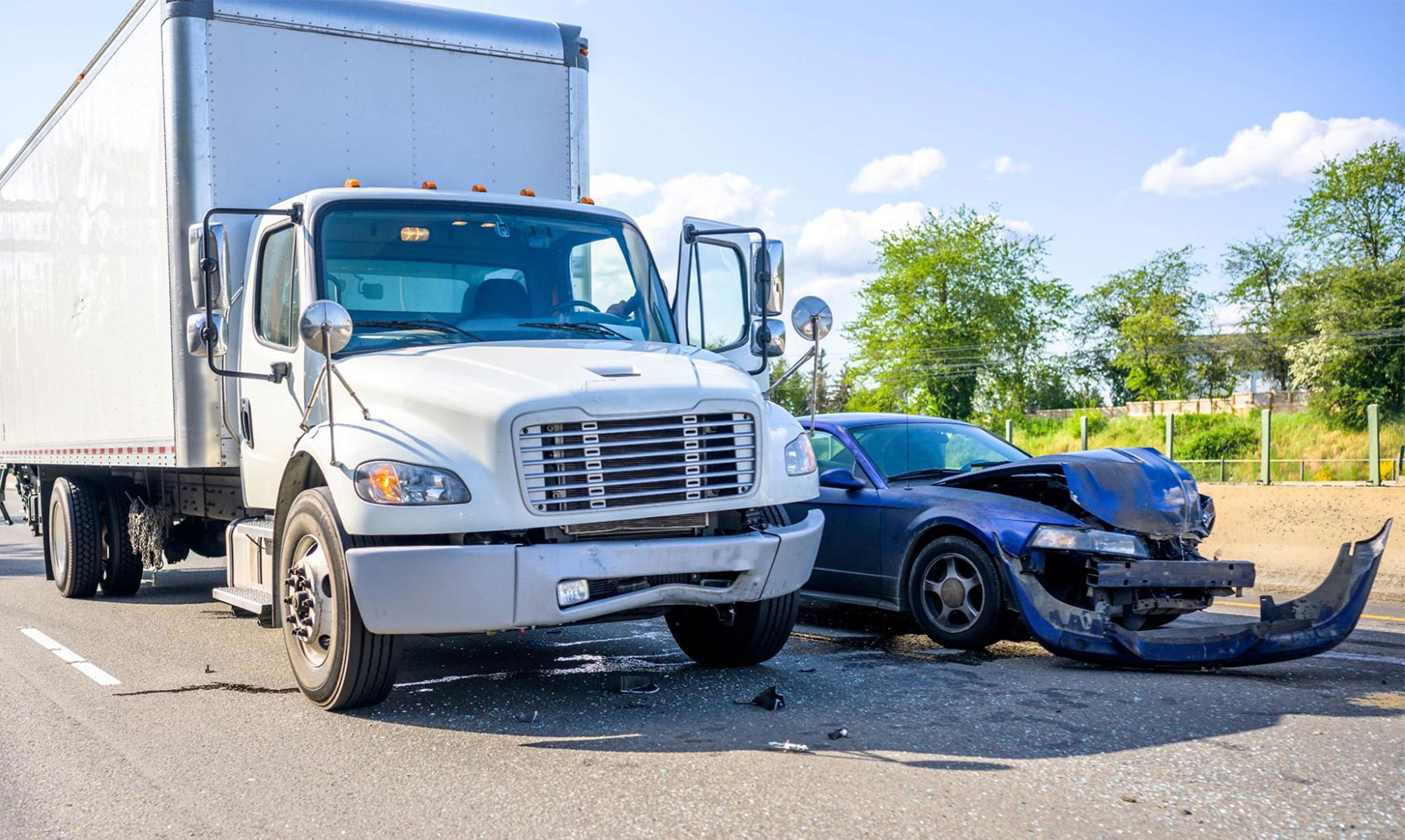 Collision of a semi-truck and a sedan, representing trucking statistics on road accidents