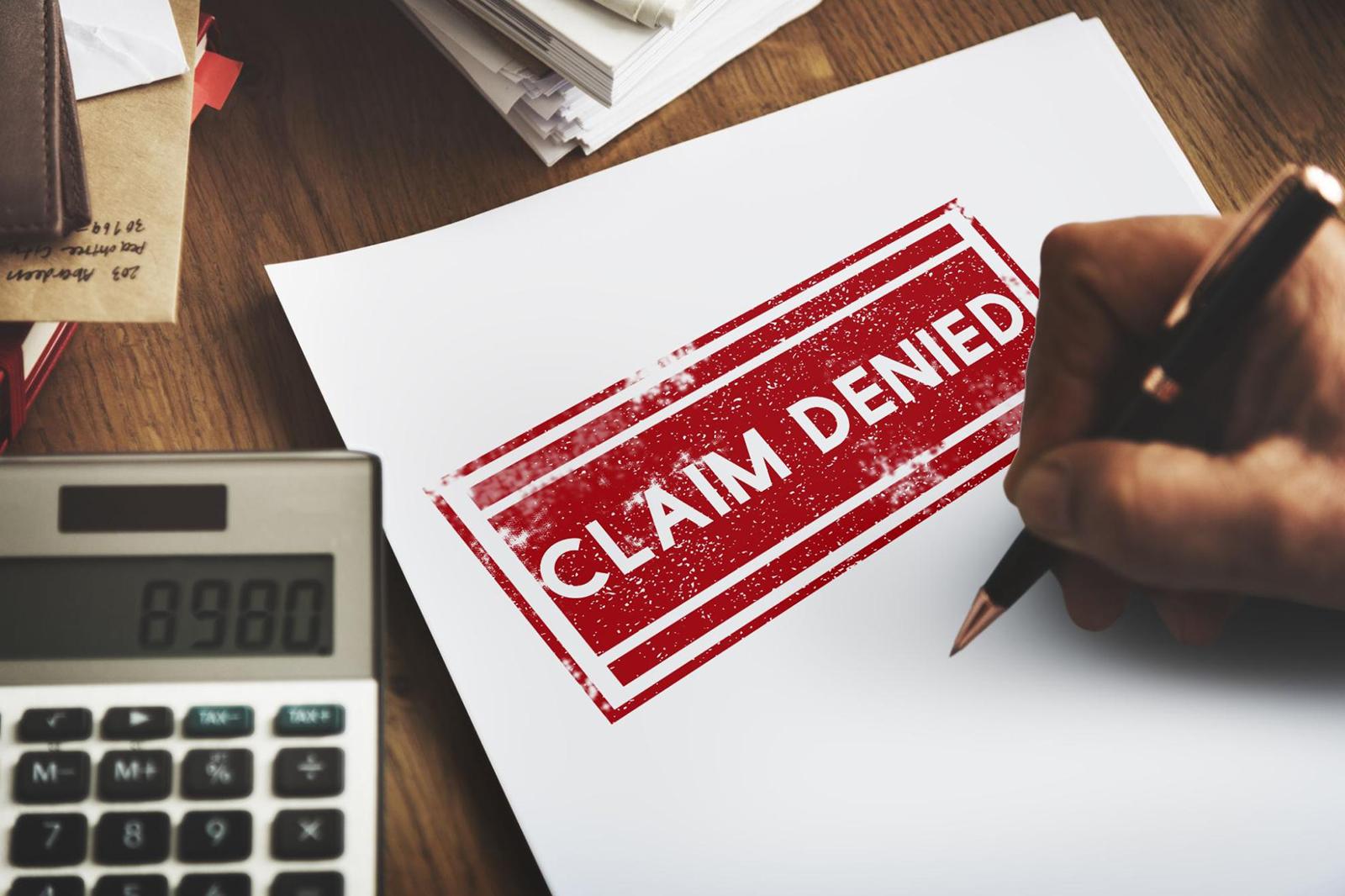 A piece of paper with the words “claim denied,” representing a void insurance policy due to a neglected insurance warranty clause