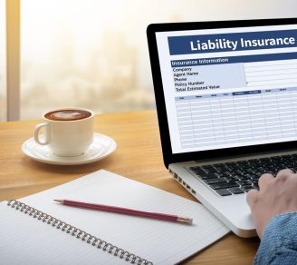 Closeup of a man filling out a CGL insurance form on his laptop