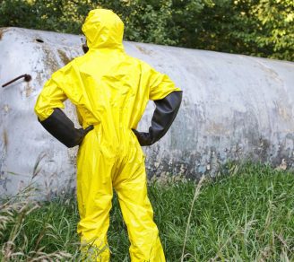 A technician examining a newly removed storage tank which could be the source of pollution liability claims