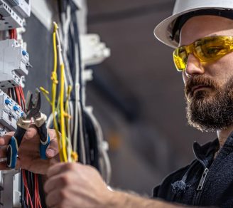 An electrician at work cutting wires