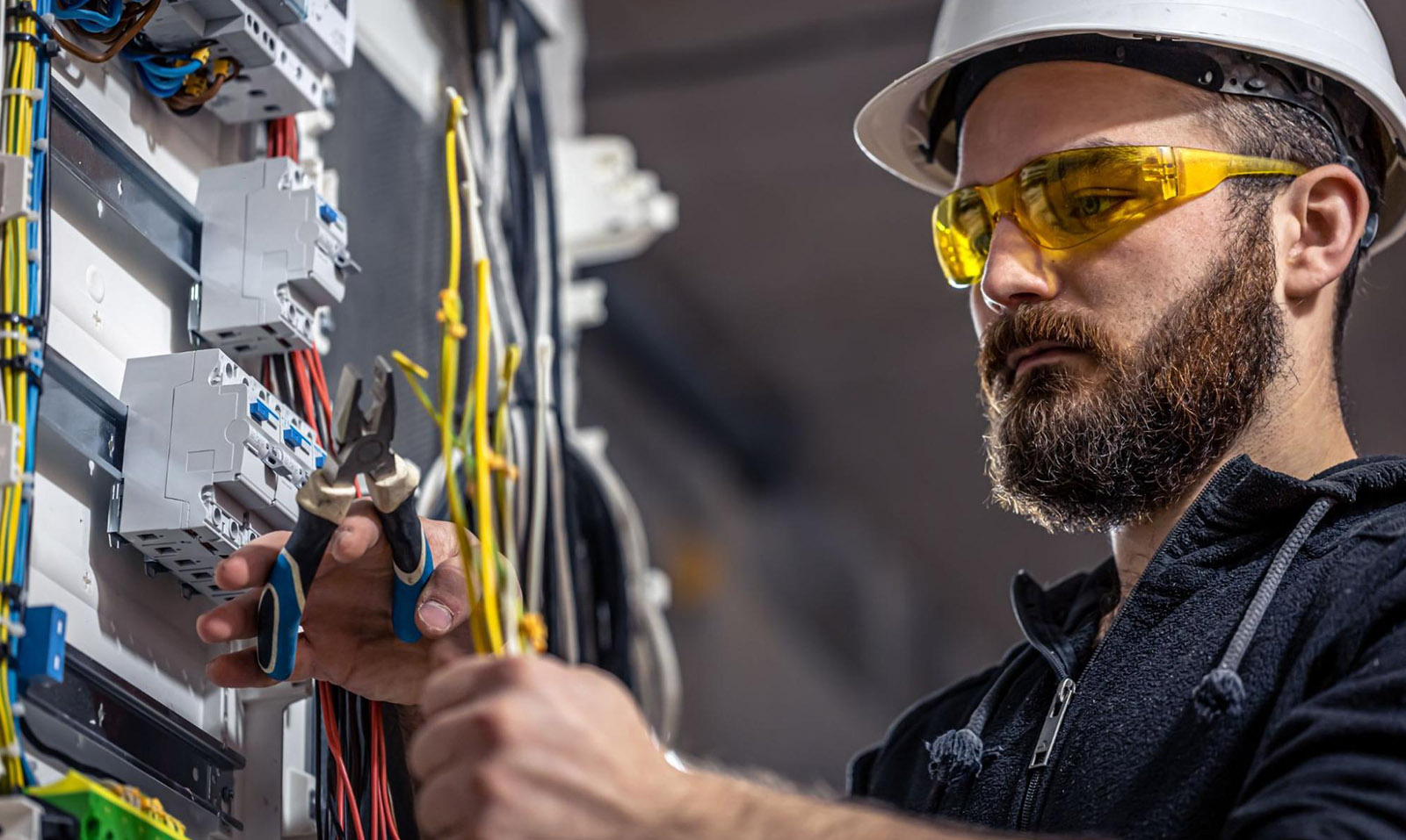 An electrician at work cutting wires