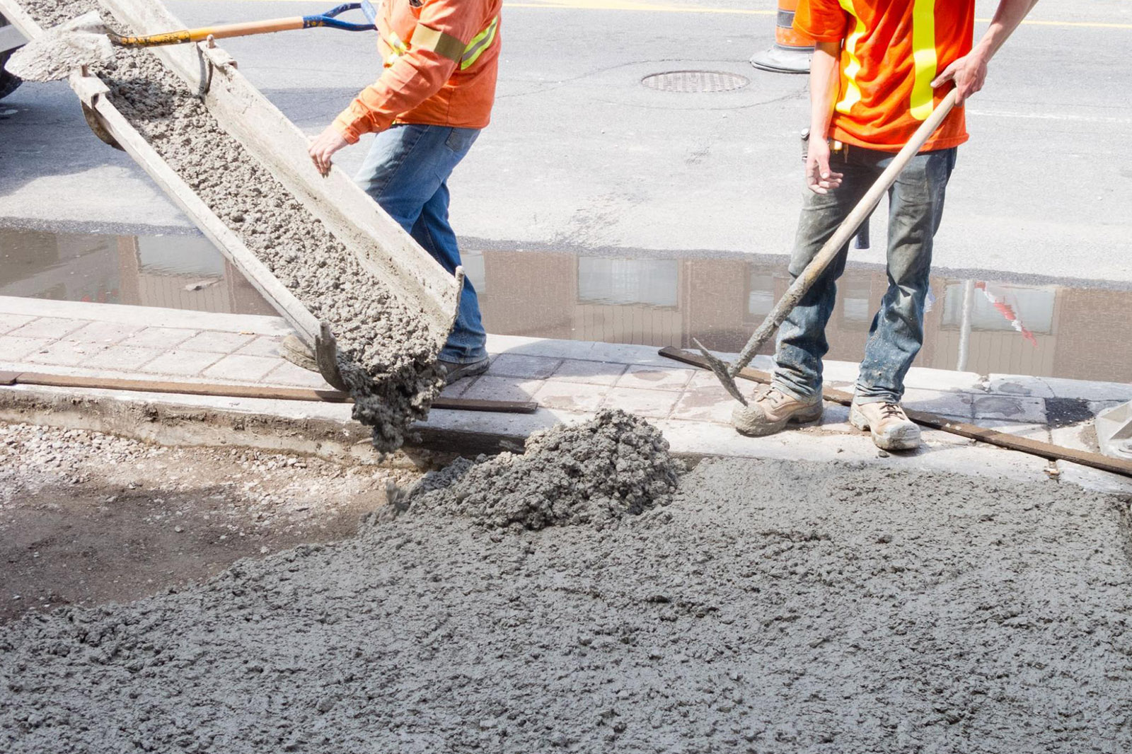 Concrete contractors, who are covered by specialty contractors insurance, clearing a construction site
