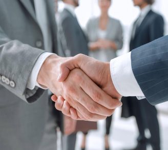 A handshake symbolizing a change in the legal entity status of a business into a partnership