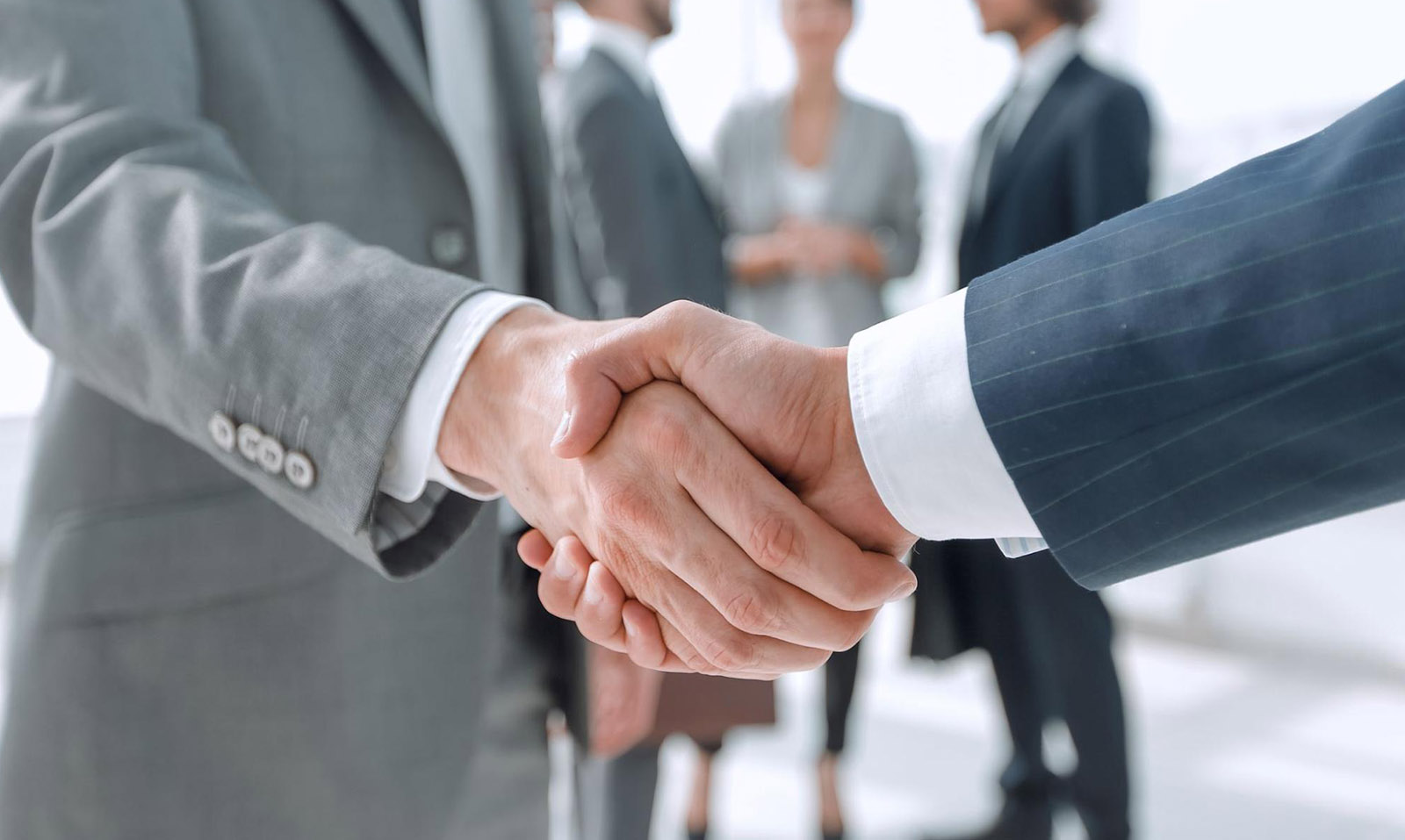 A handshake symbolizing a change in the legal entity status of a business into a partnership