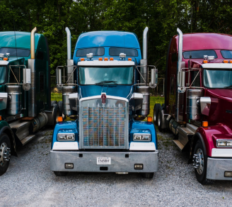 Three trucks parked together.