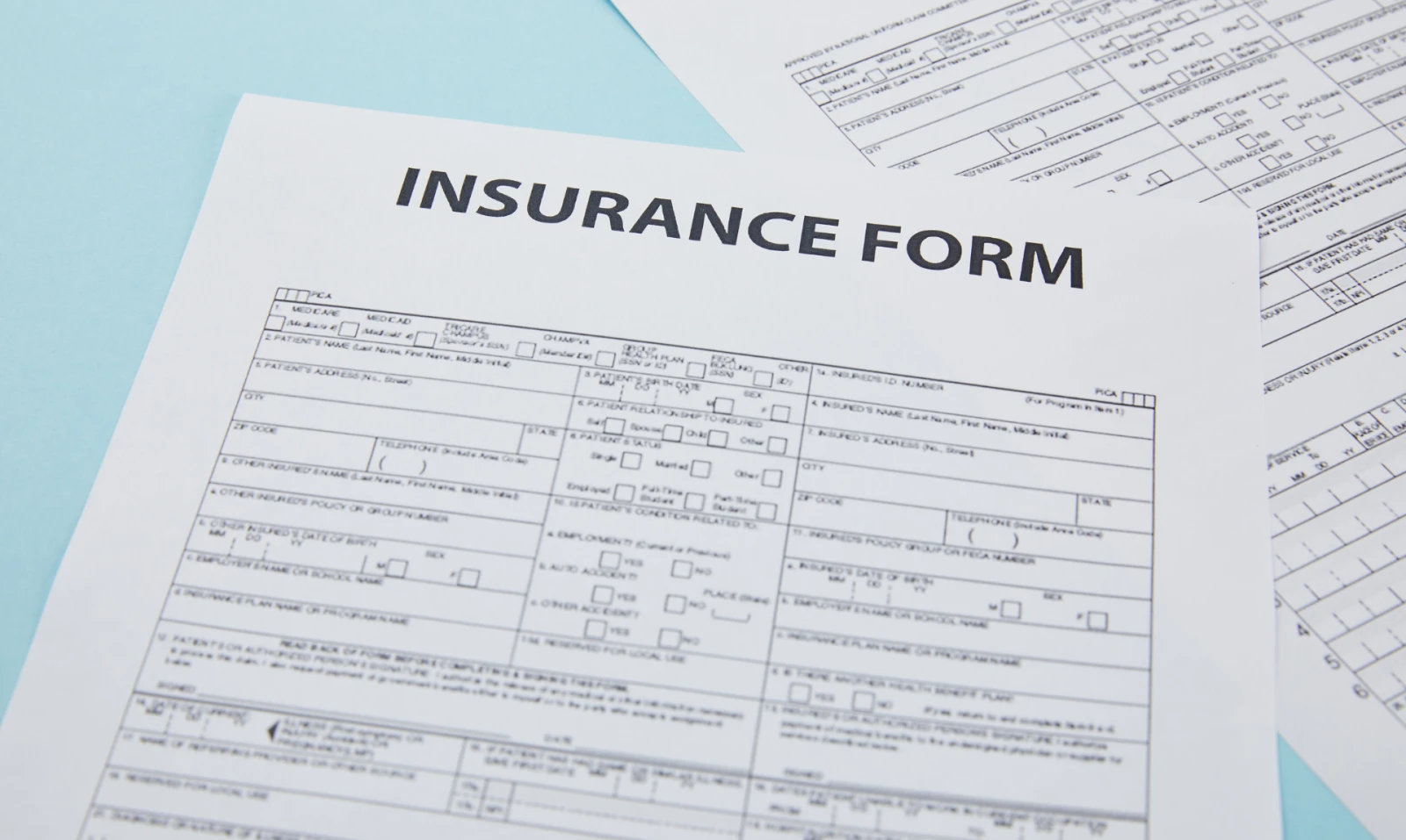 This is a studio shot of an insurance form on a light blue background