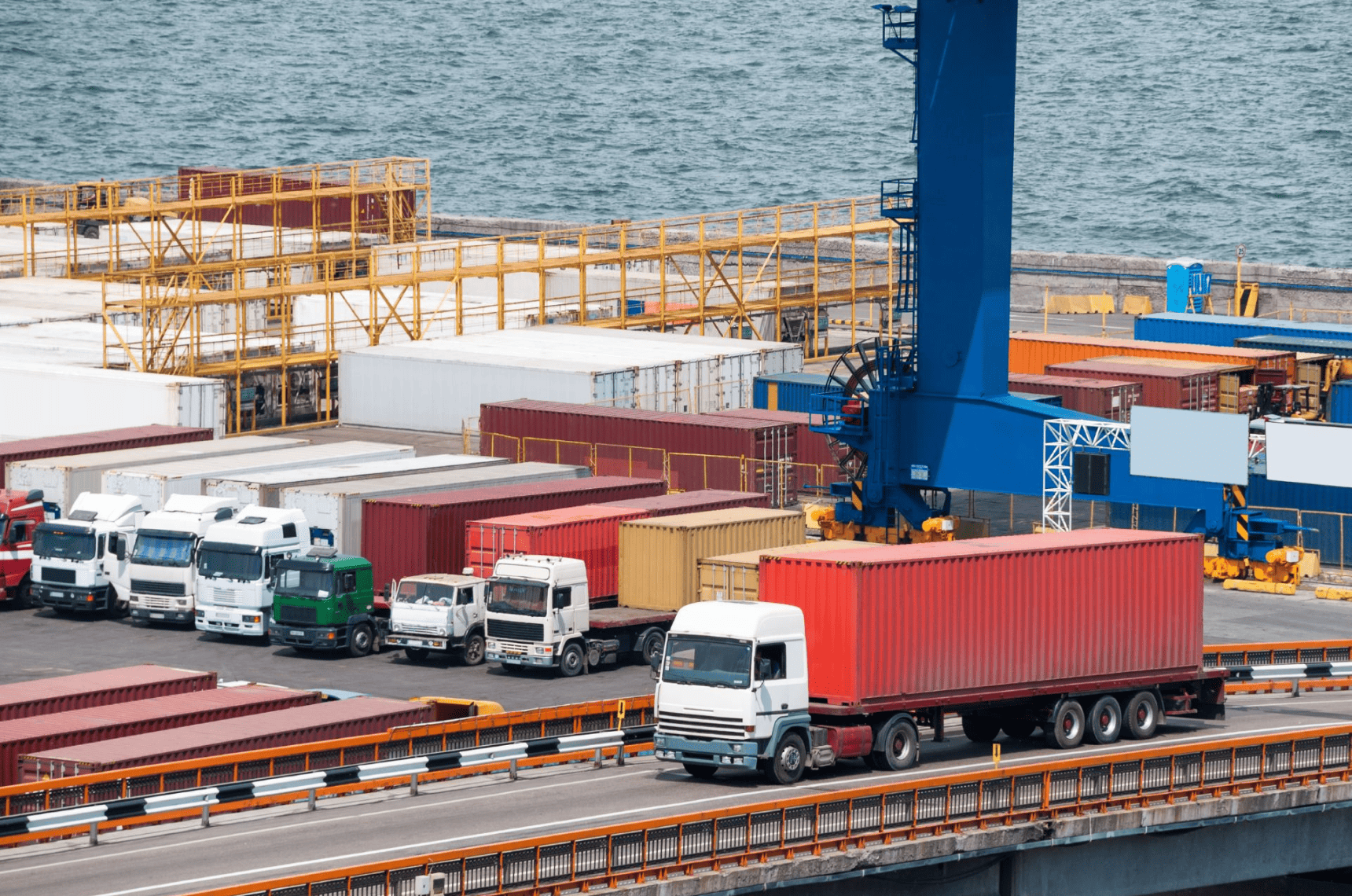 Trucks parked in a busy port.