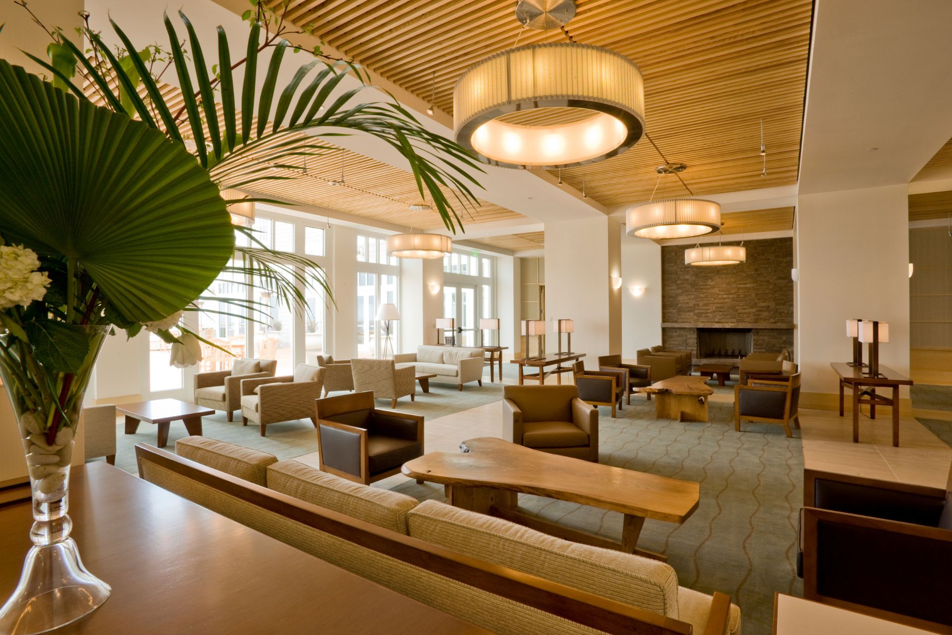 The interior of an empty hotel set up with tables and lounge sets