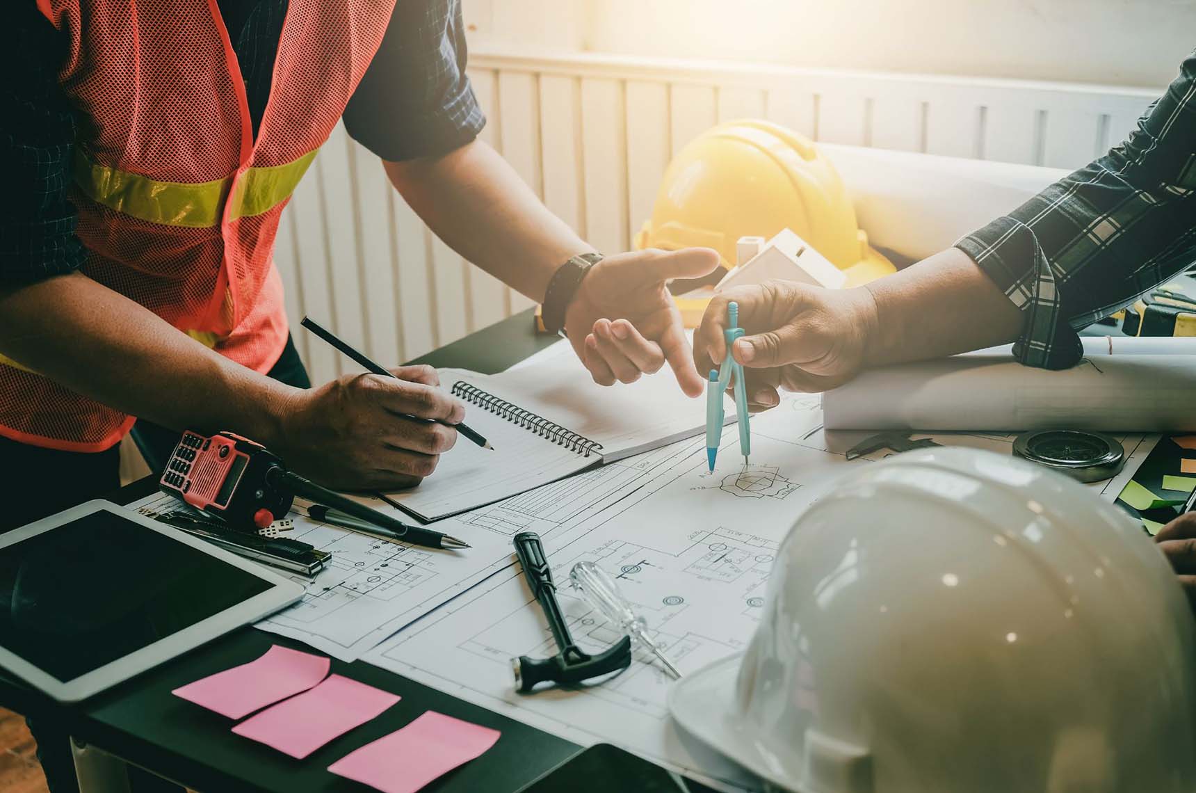 Contractors working on project blueprints