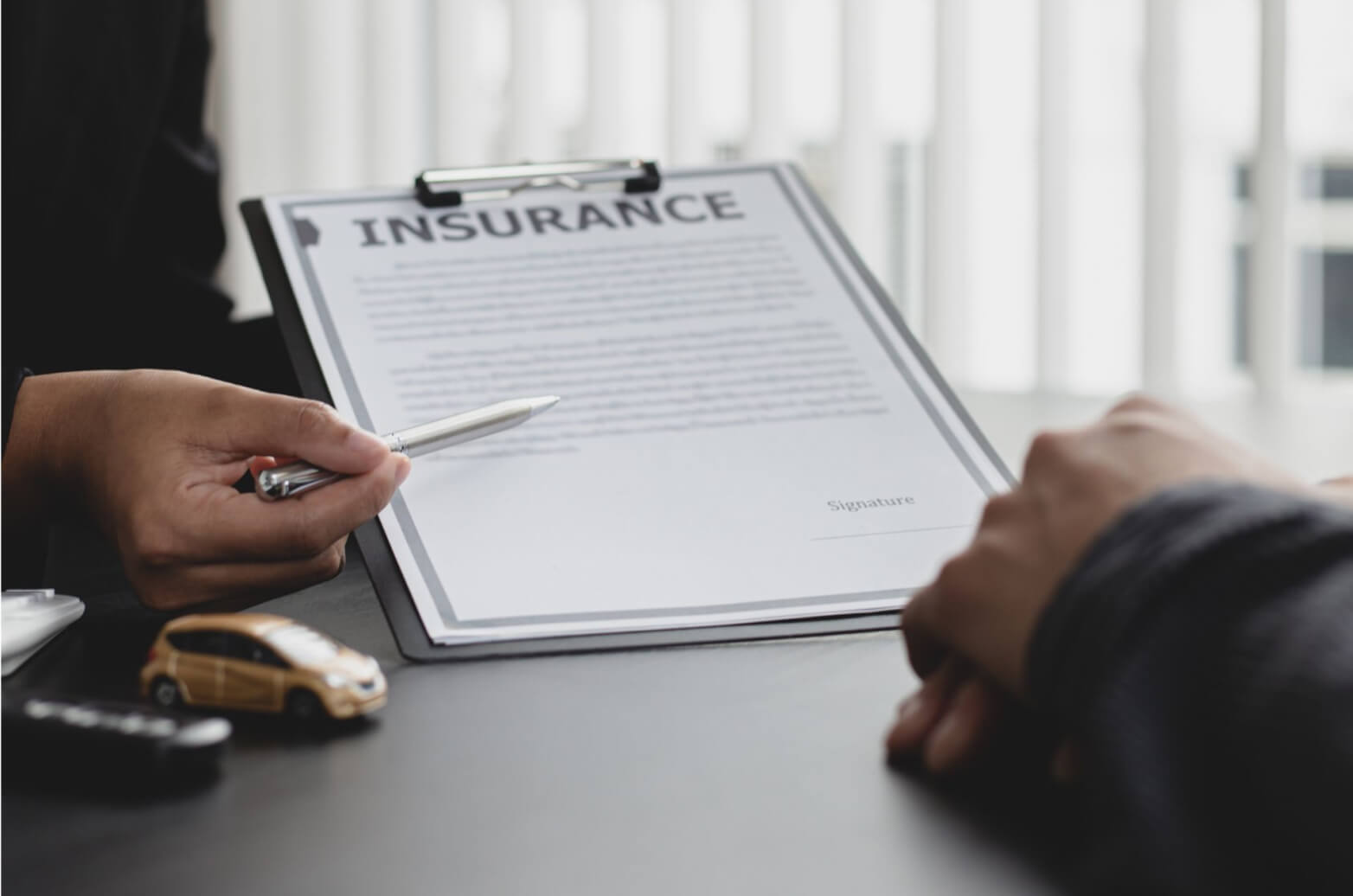An insurance broker explaining to a client how their policy works