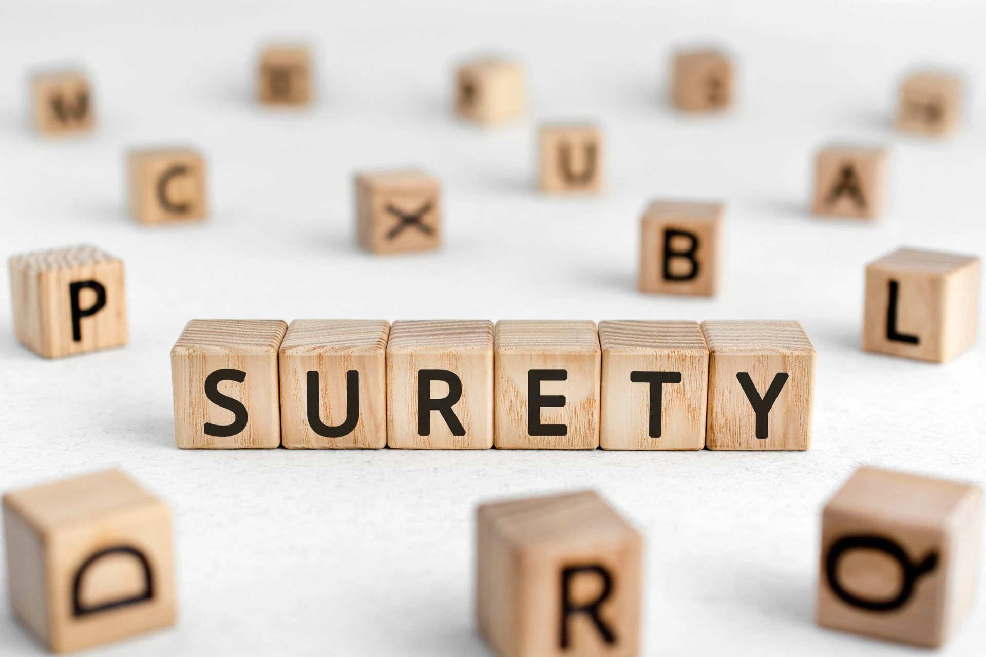 The word “surety” is spelled out using wooden blocks
