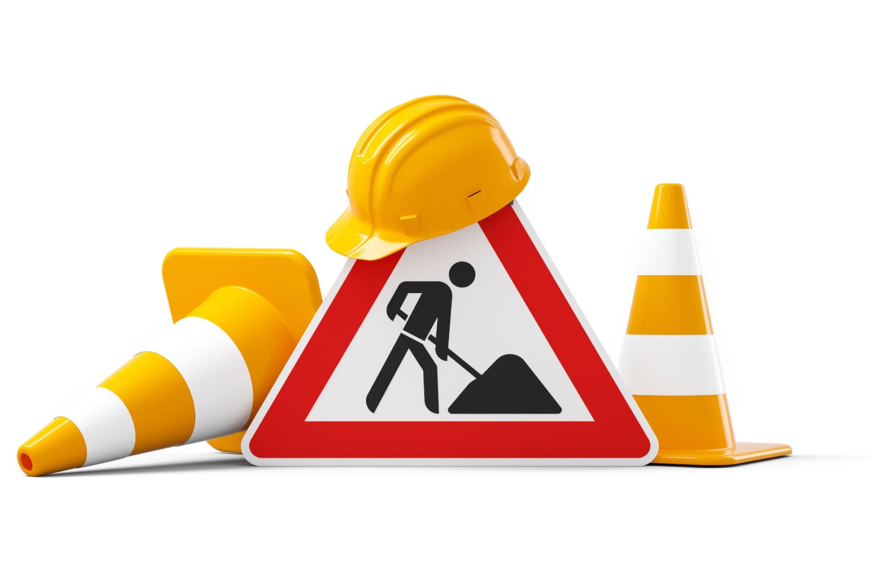  An “under construction” road sign with a yellow hard hat on top and two traffic cones on either side
