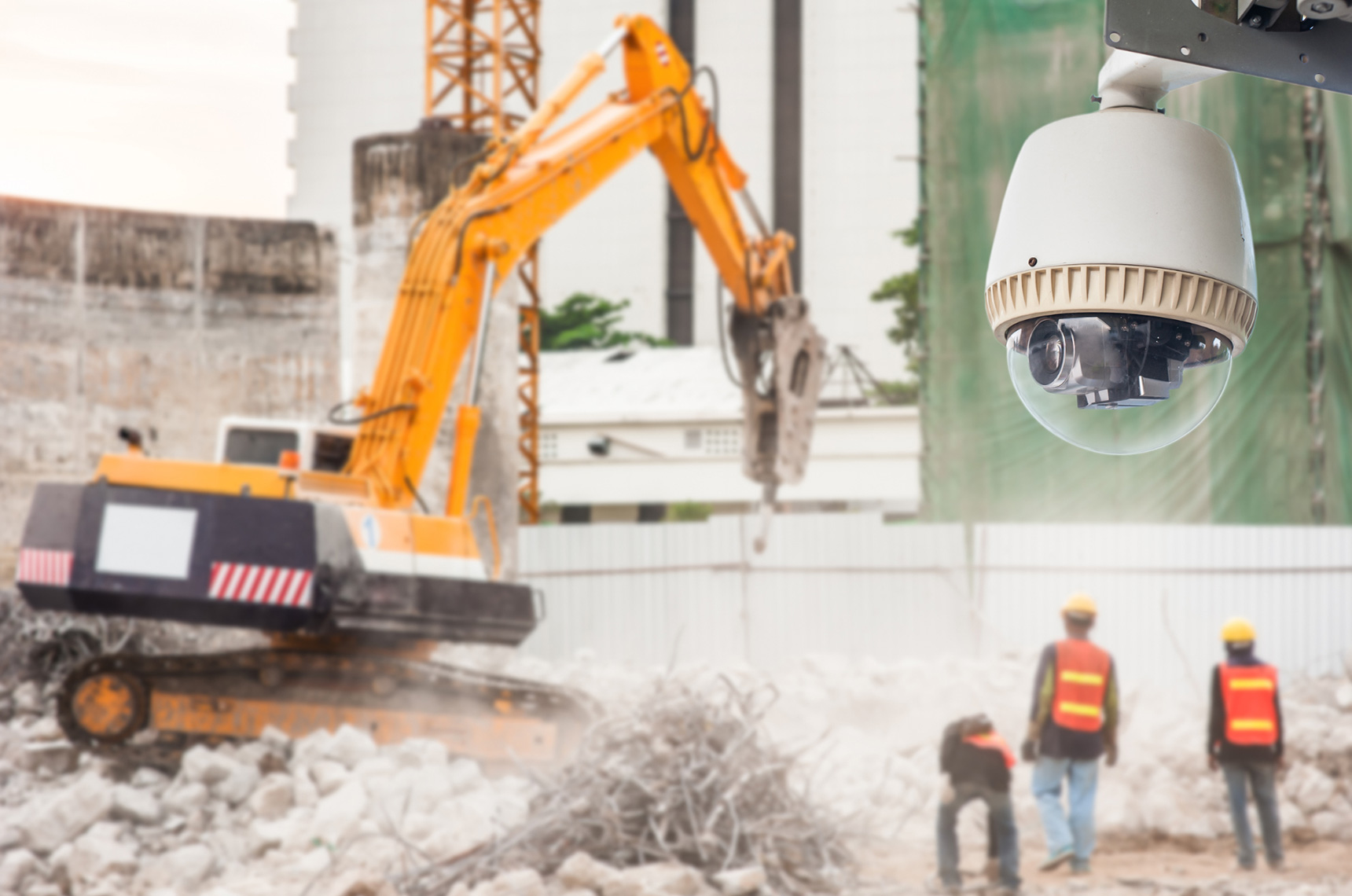  Surveillance camera on a construction site, three workers in the distance
