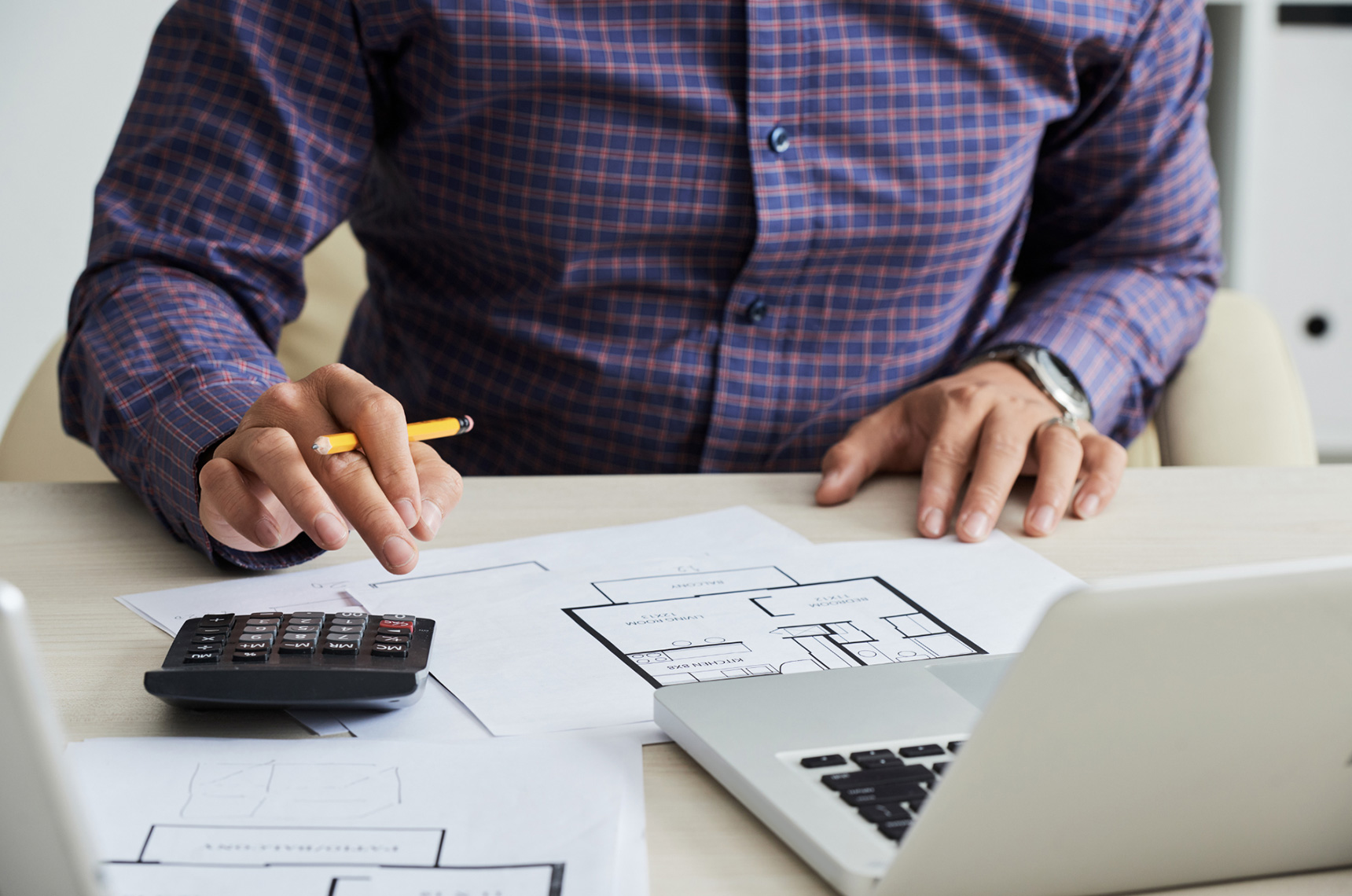 Underwriter calculating surety bond cost based on project size