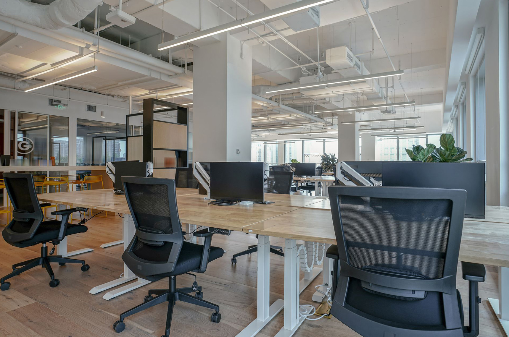 Commercial office with empty tables and chairs vacant because people work remotely