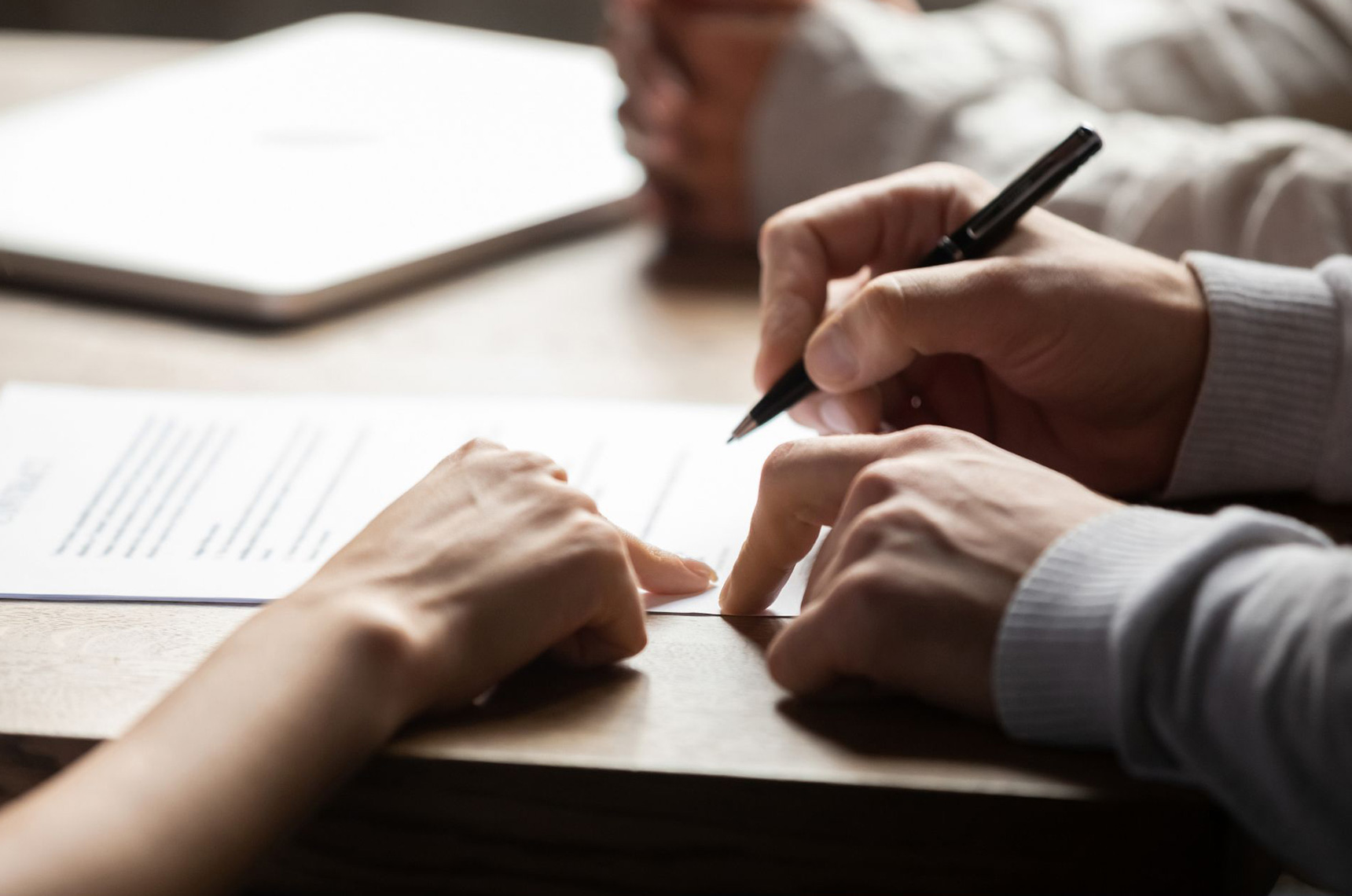 Commercial insurance broker reviewing a commercial property policy contract with the client
