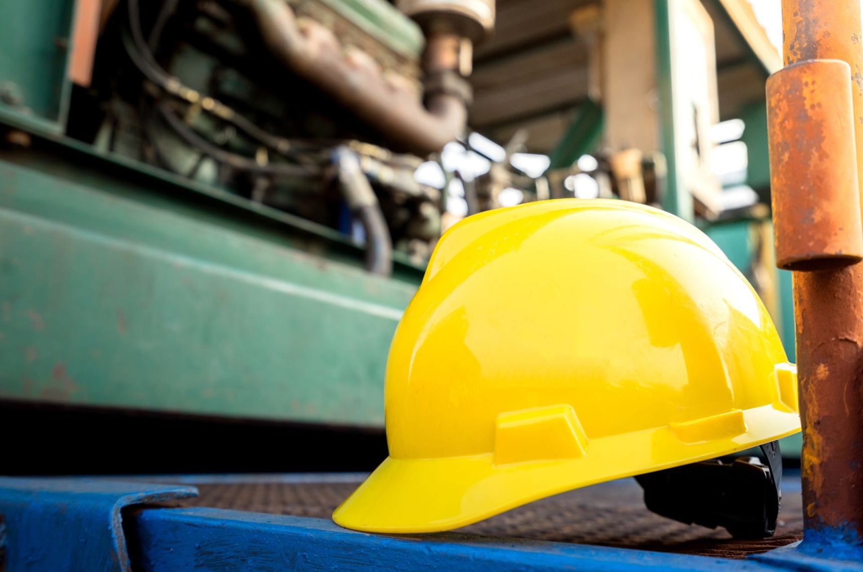 A yellow hard hat or safety helmet is placed on the working platform