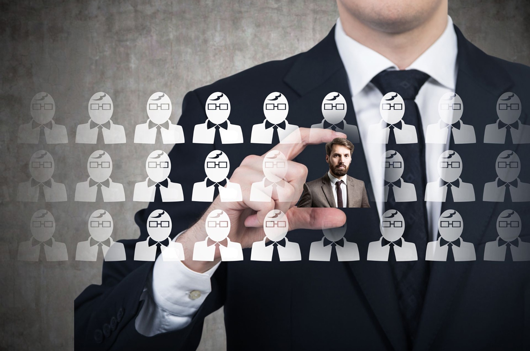 Close-up of an unrecognizable young businessman in a suit with a black tie picking up the right candidate