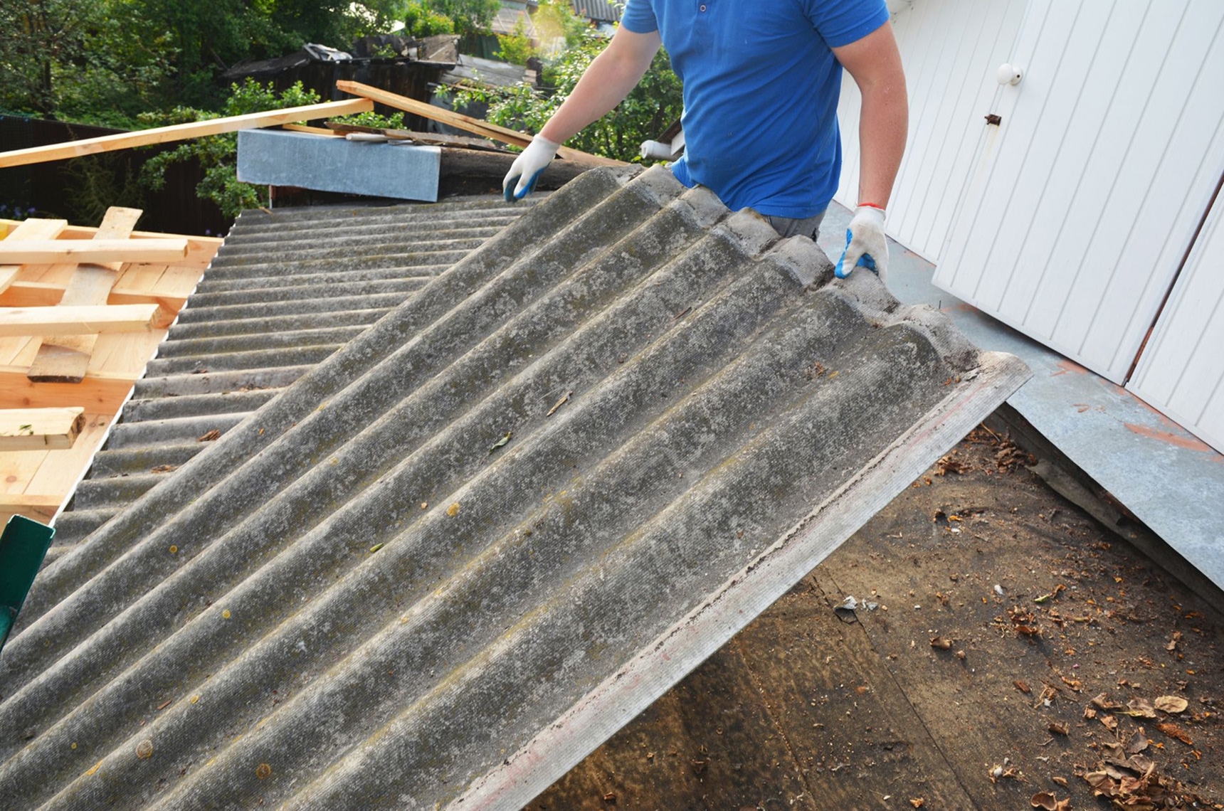 Contractor removing an old asbestos roof
