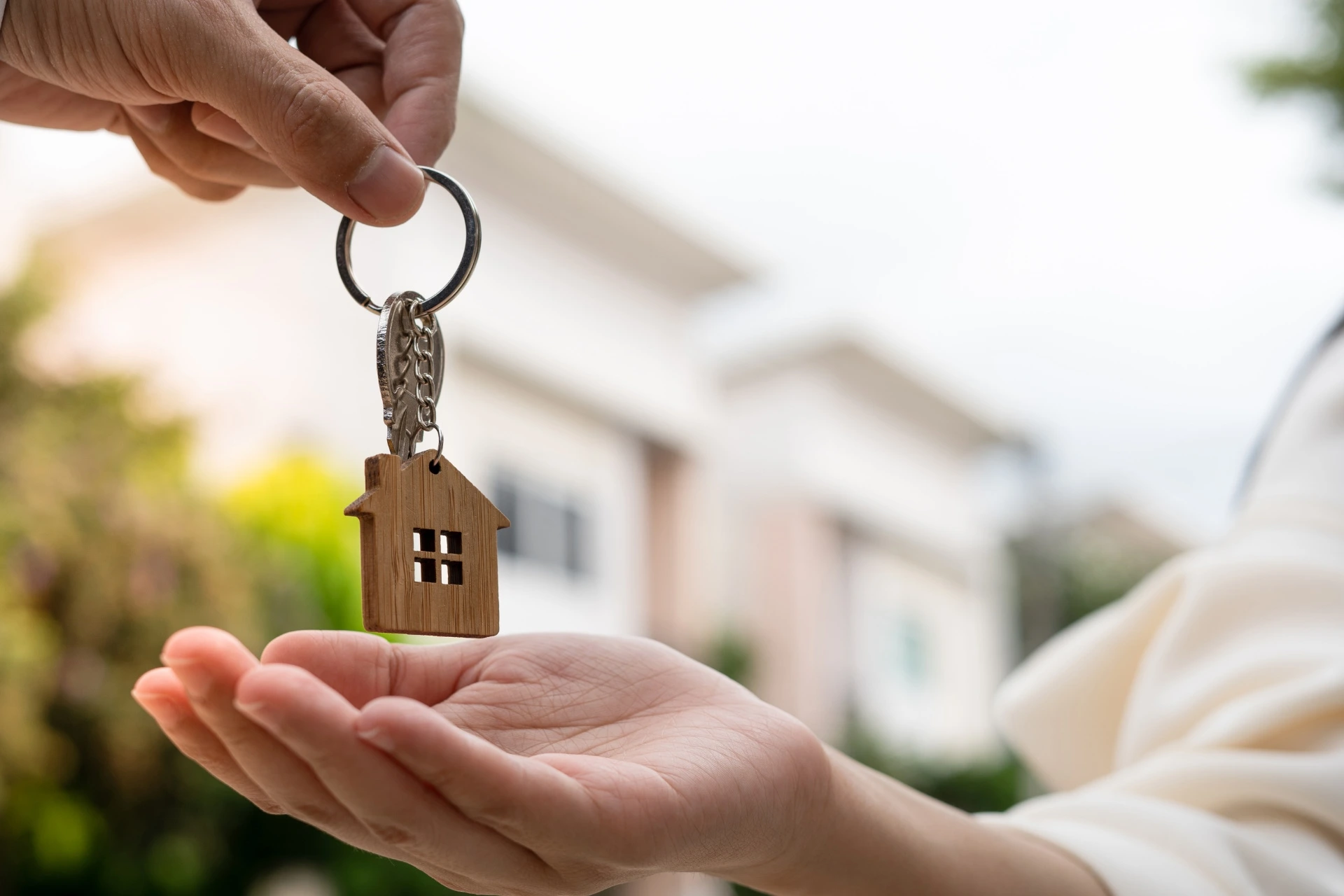 A homeowner handing their keys to a renter.