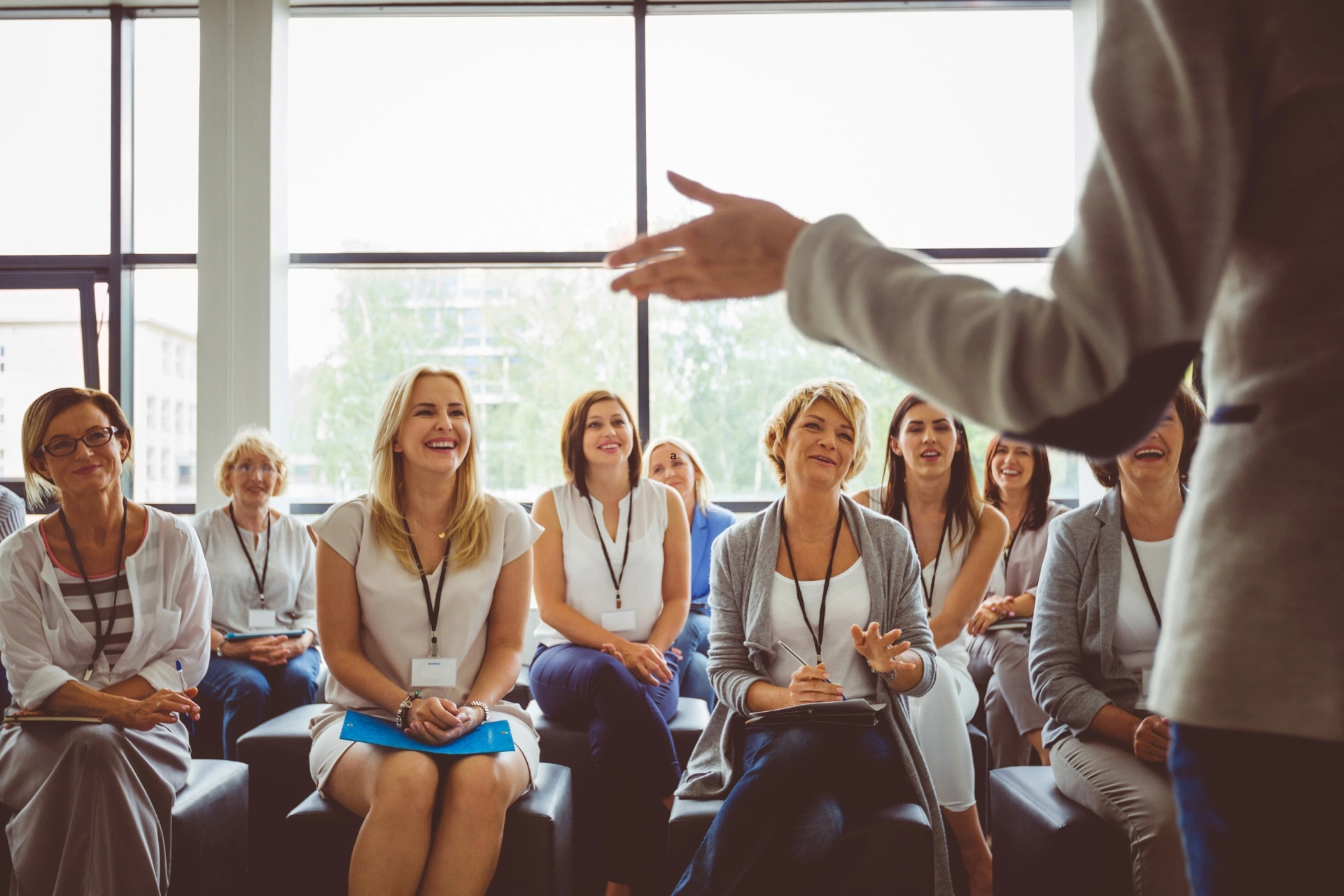 A group of female professionals attend a professional development talk.