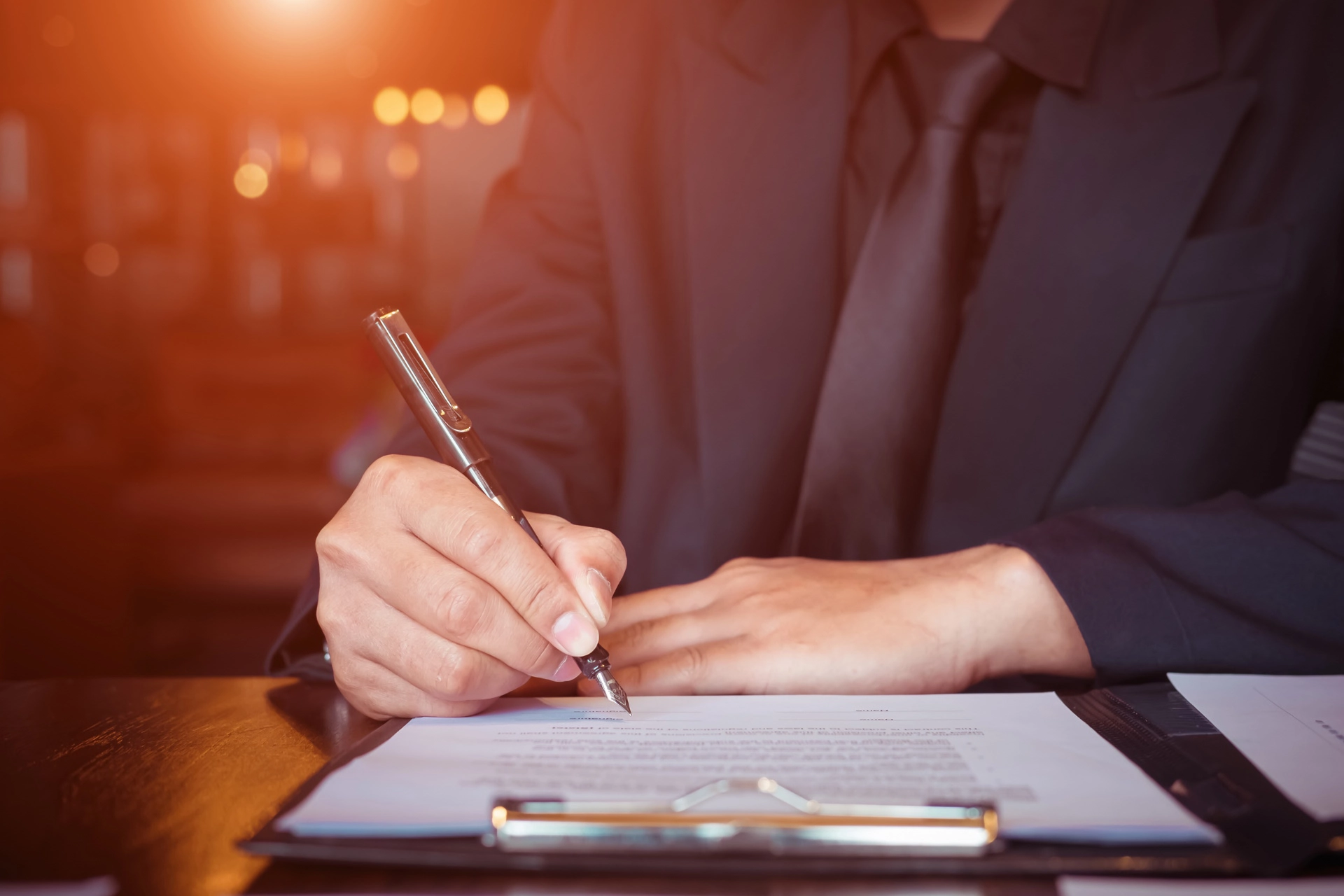A business person signing insurance forms