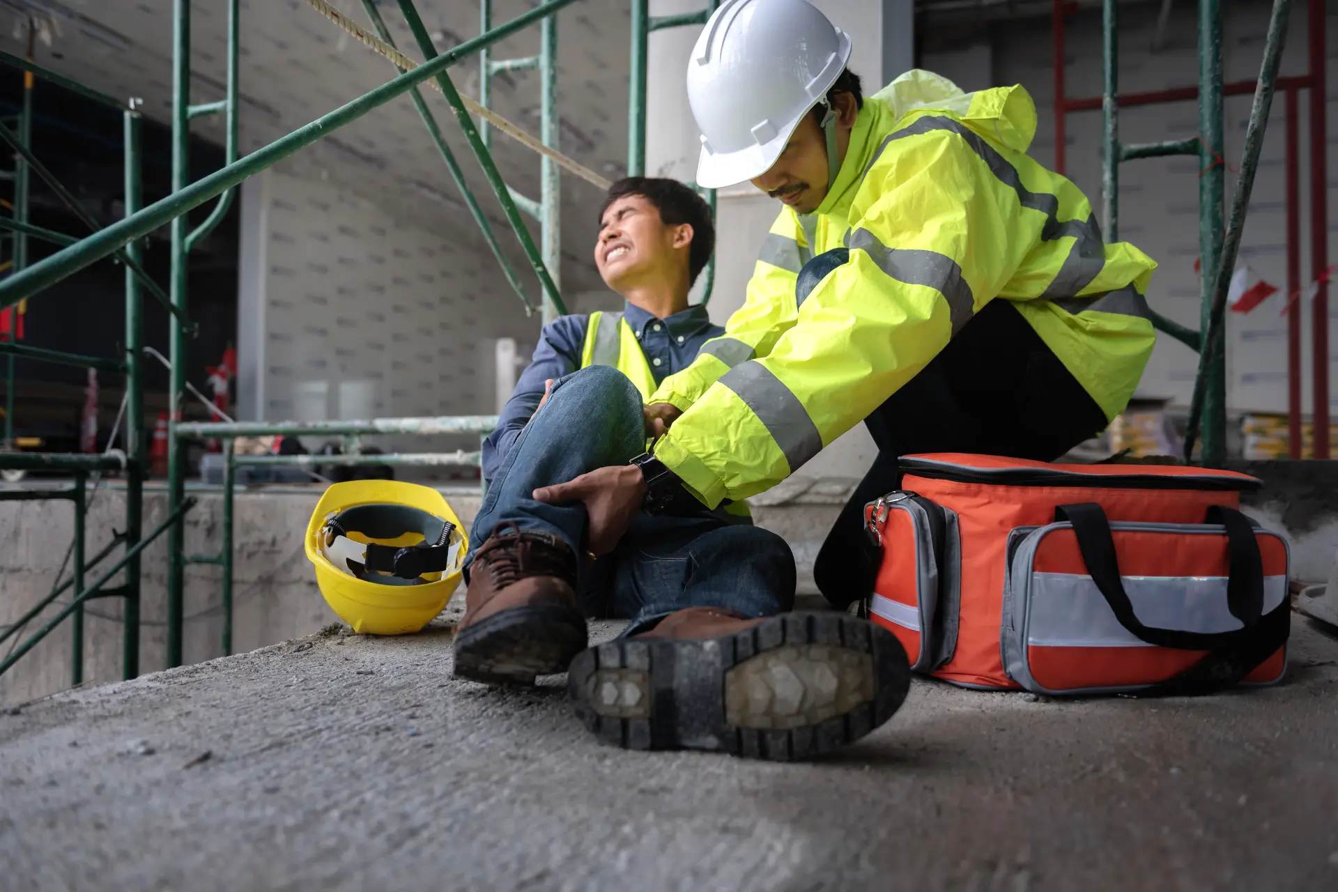A construction contractor suffering from a fall, attended to by an EMT
