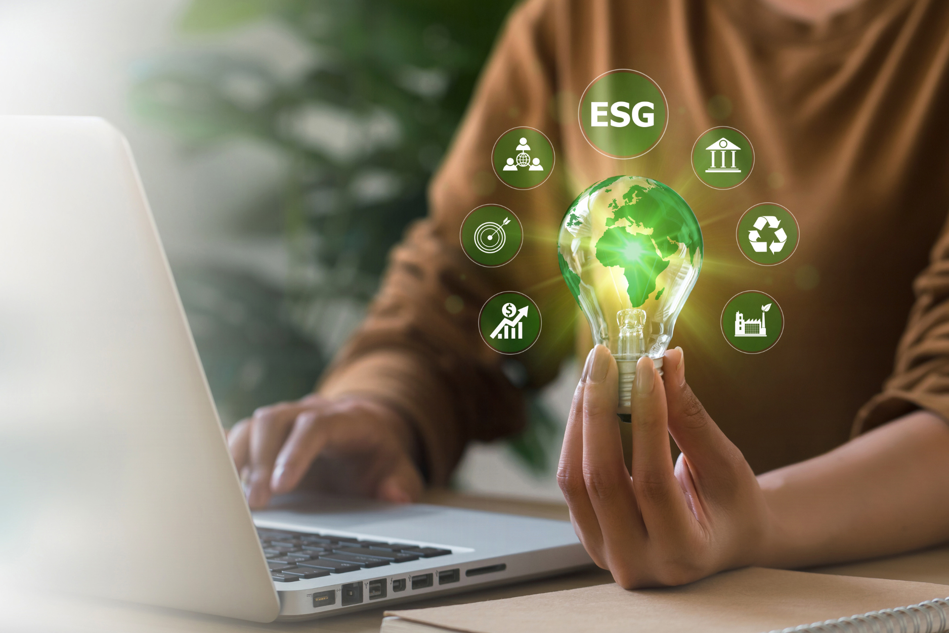 A businesswoman holding a lightbulb symbolizing the Earth and corporate environmental sustainability initiatives