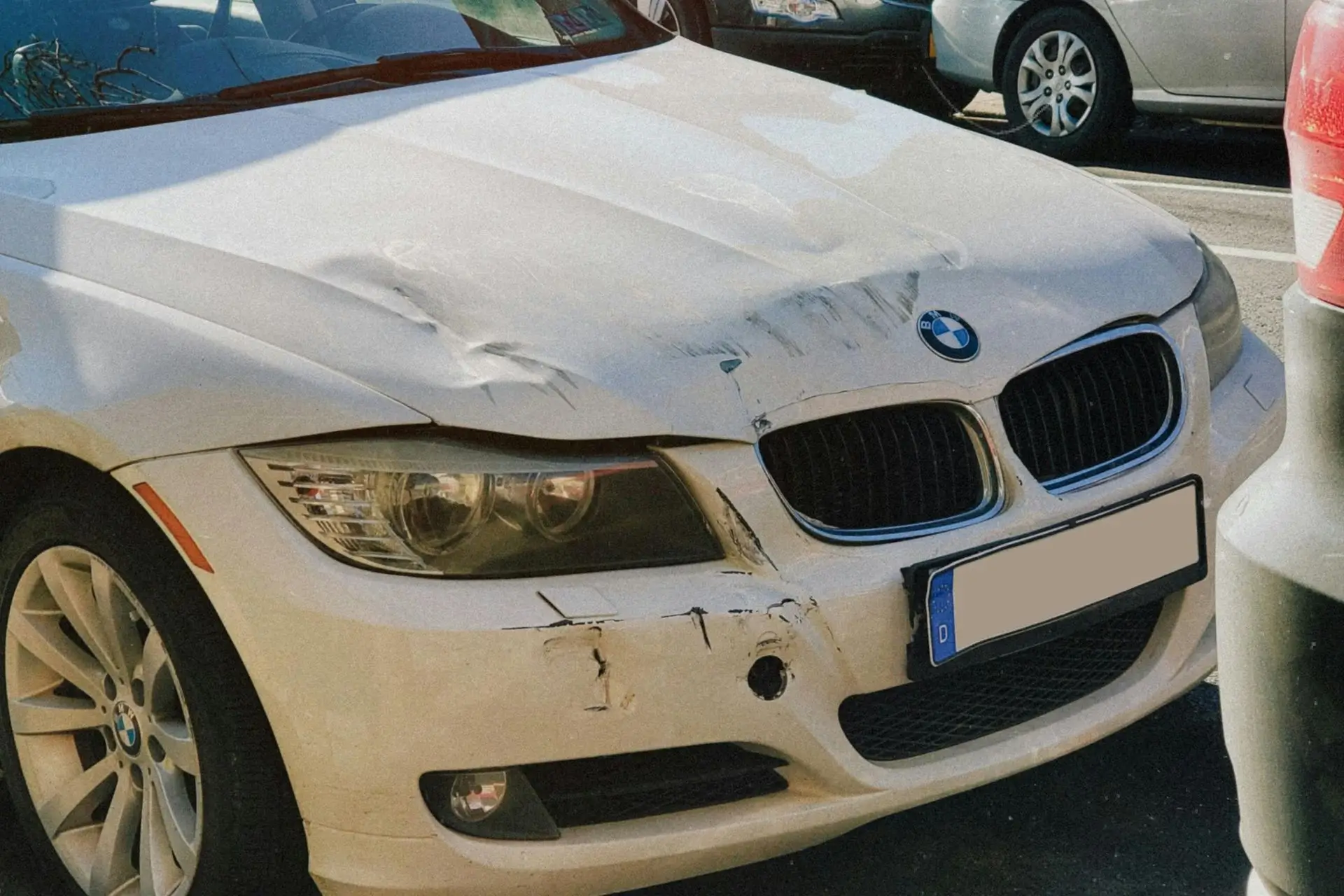A damaged white BMW sedan