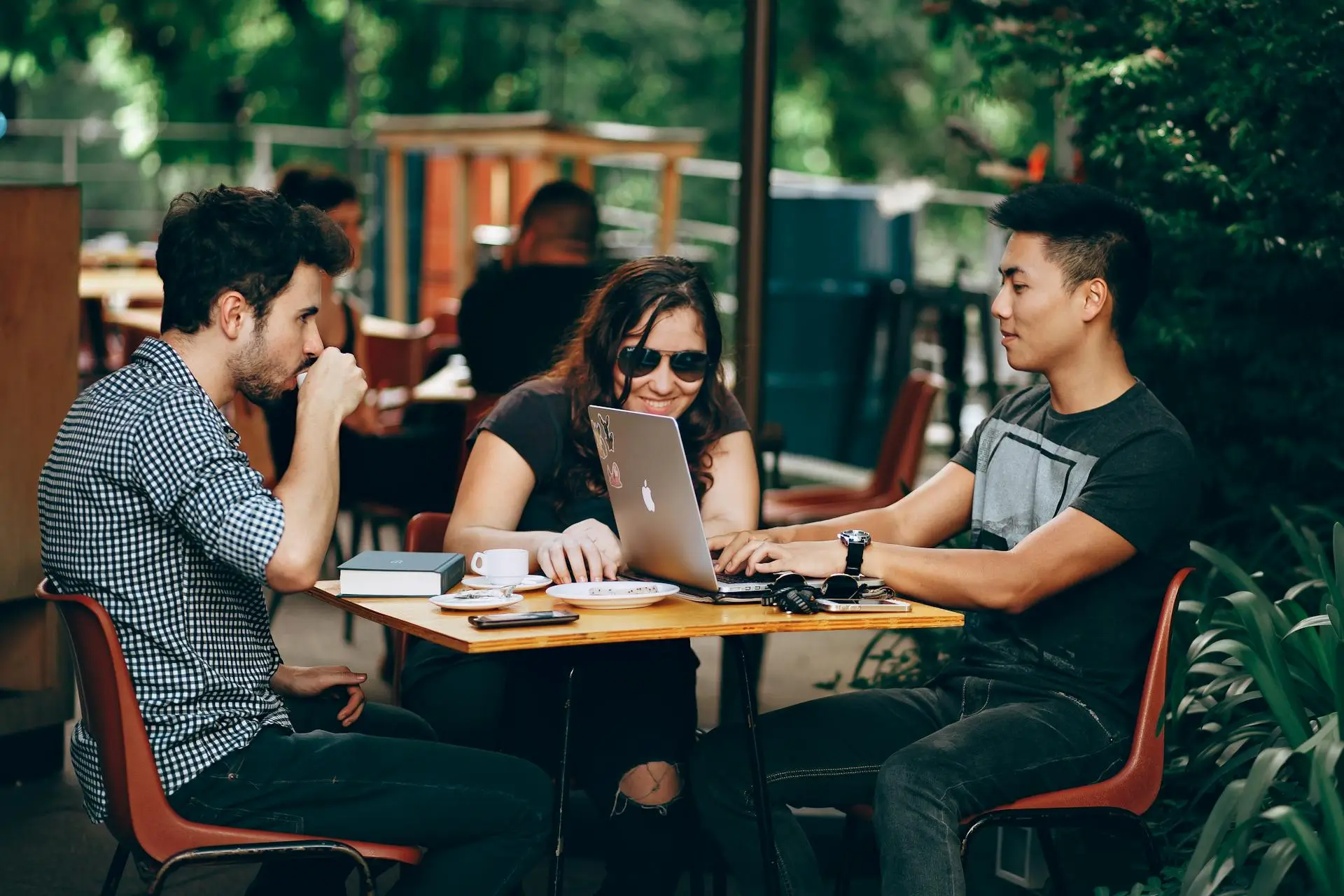 Three people working together at a coffee shop