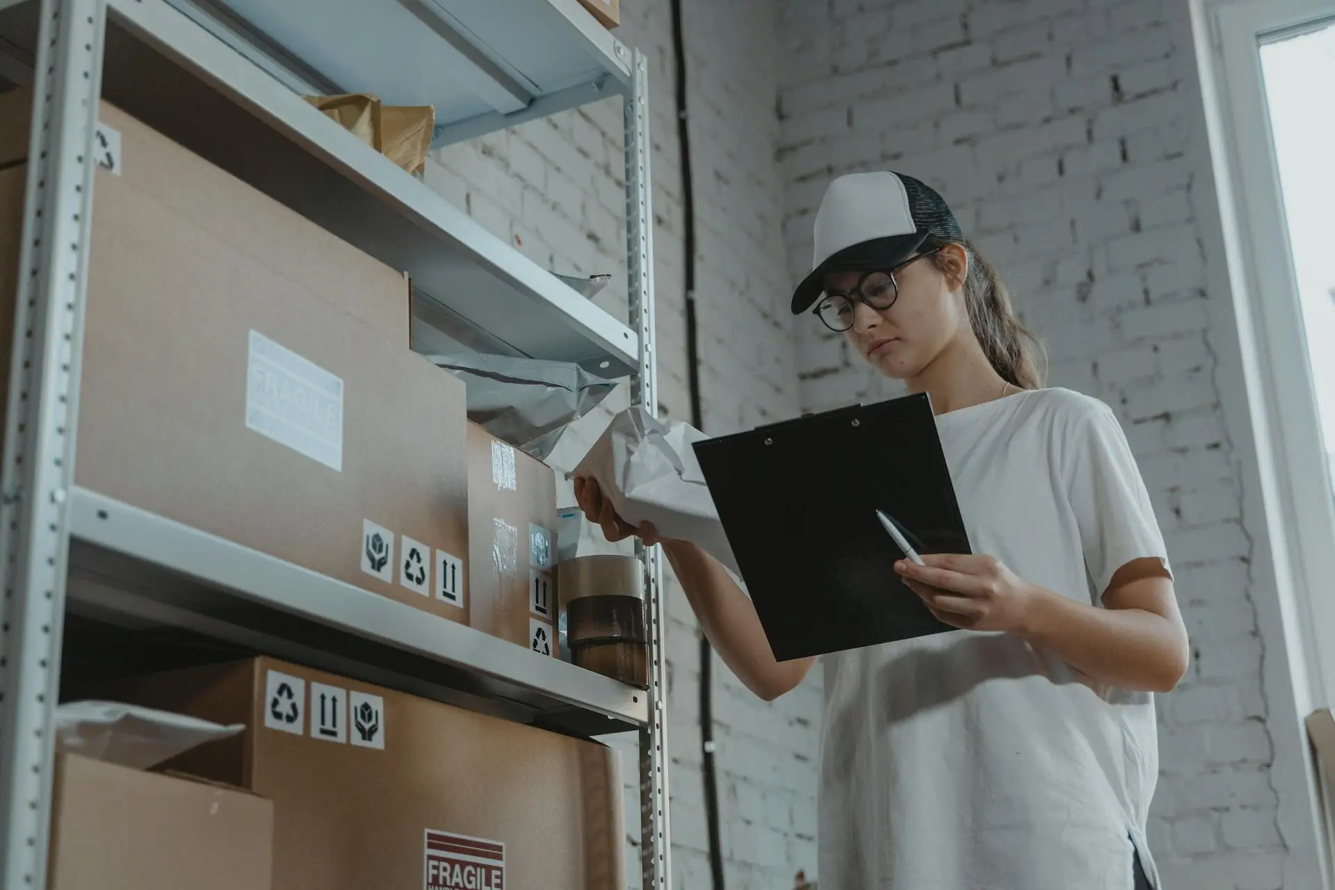 Woman wearing a trucker hat doing inventory