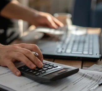 A small business owner calculating employers' liability insurance cost in Canada