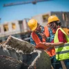 Contractors at a construction site inspecting waste