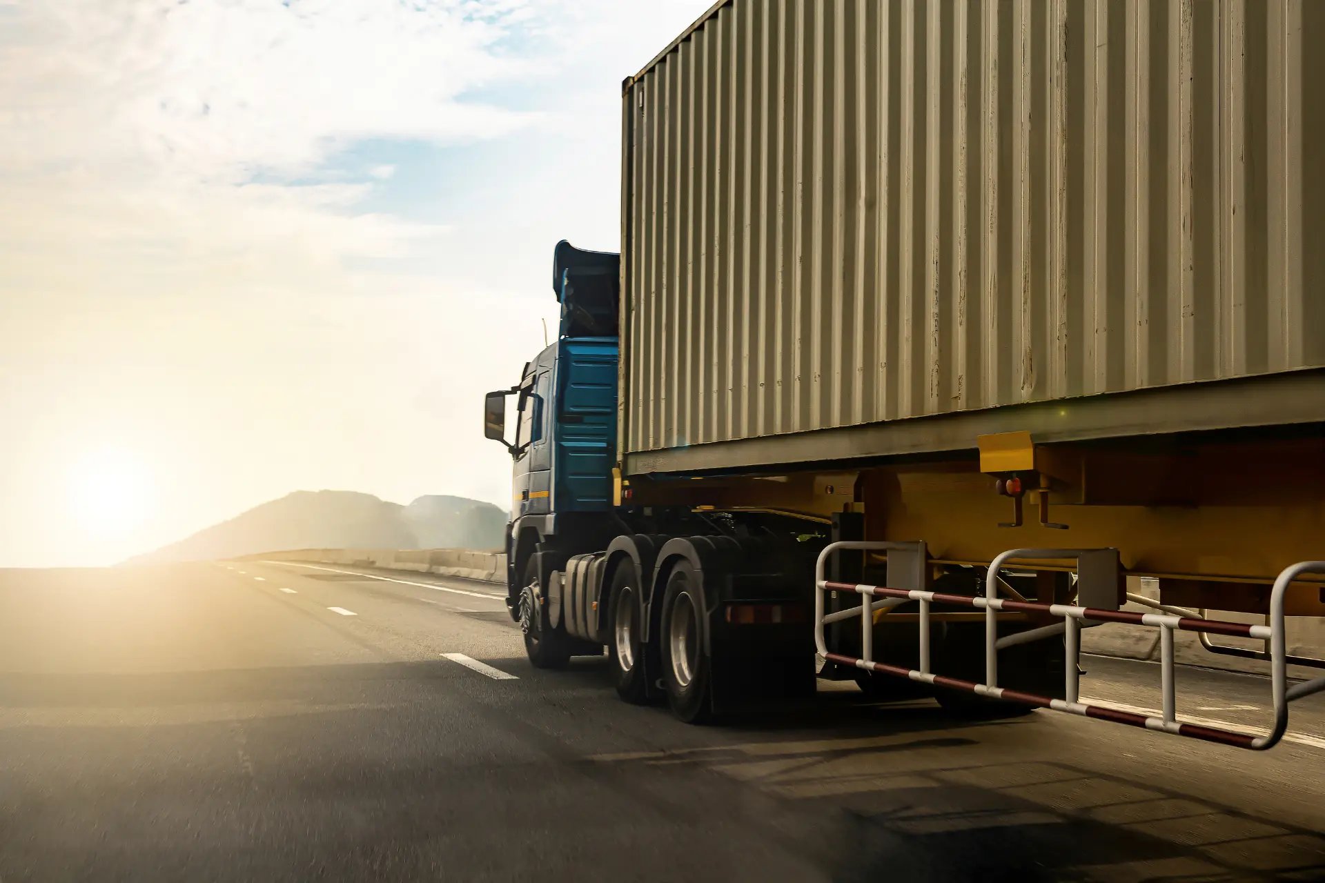 A cargo truck in transit on a highway
