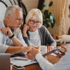 An older couple reviews an insurance document for their new apartment.
