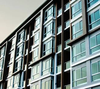 A condo with metal and glass in the afternoon.