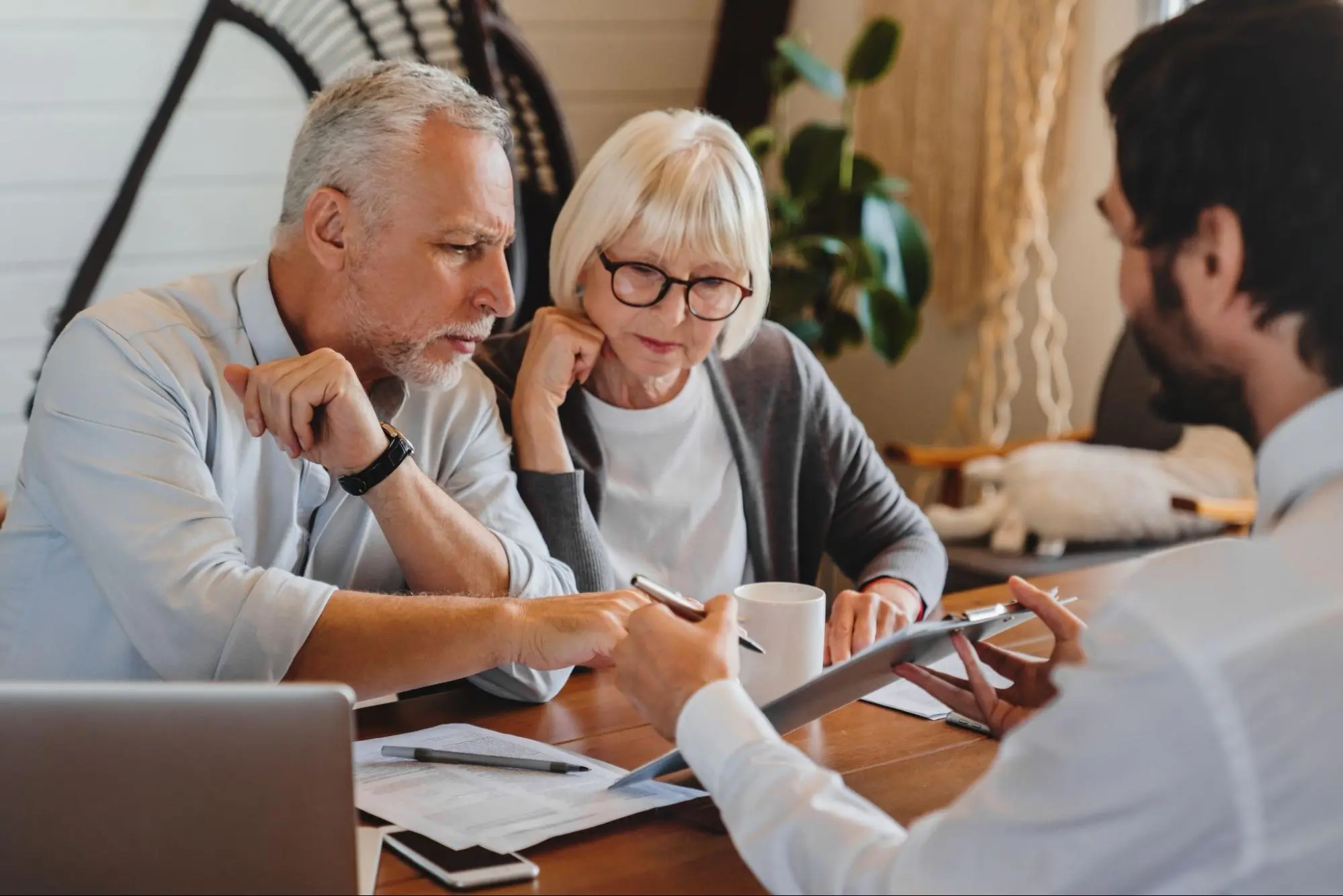 An older couple reviews an insurance document for their new apartment.