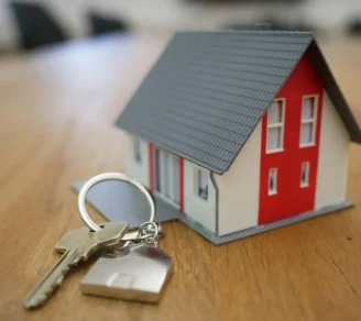 A miniature house beside a silver key